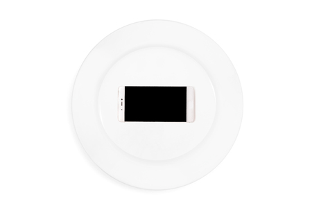 Mobile phone served on empty serving plate. Concept. Isolatedの写真素材