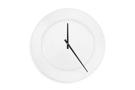 Top view of a empty serving plate as a clock with arrows on the white background. Concept. Isolated