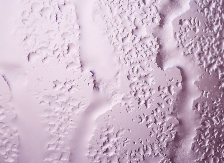 The texture of close up of pink water drop of melted frost on the glass. Winter background ant texture.の写真素材