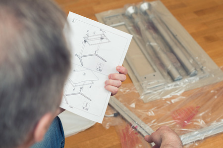 Instruction for furniture assembling in the male hands for self assembly.の写真素材
