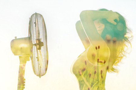Double exposure of a girl body with a fan and the spring field. Spring and early summer conceptの写真素材