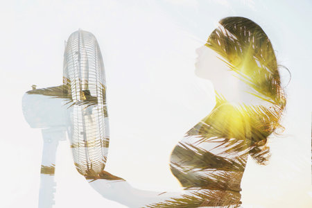 Double exposure of a girl body with a fan and palm tree.