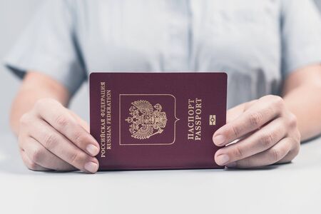 Immigration and passport control at the airport. woman border control officer puts a stamp in the Russian passport. Conceptの写真素材