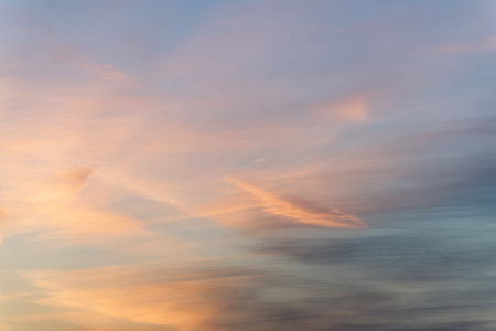 sunset background. sky with soft and blur pastel colored clouds. sunshine through the gradient cloud...