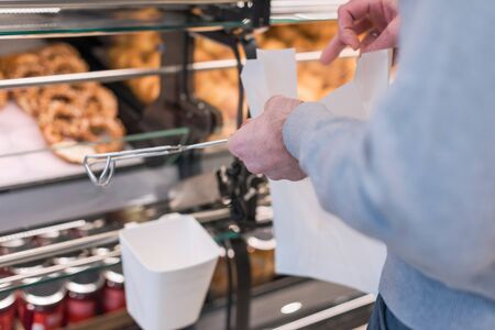 Man buying pretzels in a pastry shop for Christmasの写真素材