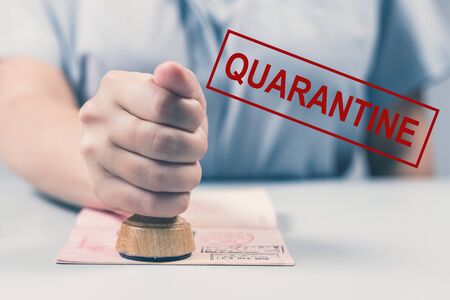 Quarantine, closure of the borders of countries due to the coronavirus COVID-19. woman border control officer with passport. Worldwide pandemic concept.の写真素材