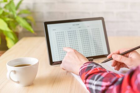 Online exam. girl student testing exercise. Examination test on the tablet for school, university. multiple choice answer sheet. Home school, online study. Pandemic, online studyの写真素材