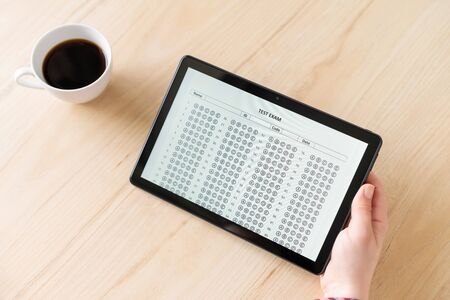 Online exam. girl student testing exercise. Examination test on the tablet for school, university. multiple choice answer sheet. Home school, online study. Pandemic, online studyの写真素材