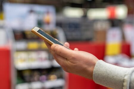 Man with the phone with qr code payment, contactless payment in the store, online shopping , cashless technology. conceptの写真素材