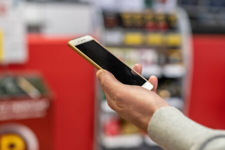 Man with the phone with qr code payment, contactless payment in the store, online shopping , cashless technology. conceptの写真素材