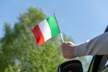 Man holding Italy flag from the open car window. Conceptの写真素材