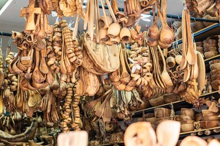 Traditional Cretan handmade olive wood kitchen tableware objects made of olive wood, souvenir market store.の写真素材