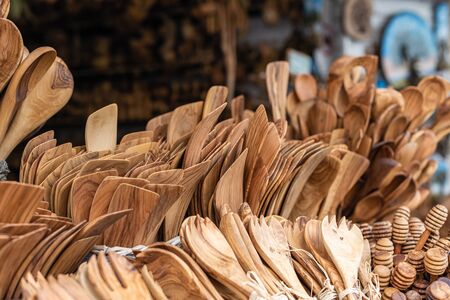 Traditional Cretan handmade olive wood kitchen tableware objects made of olive wood, souvenir market store.の写真素材