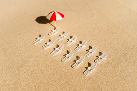Aerial view of many sunbed, lounge, umbrella on sandy private beach. copy space. Summer and travel...