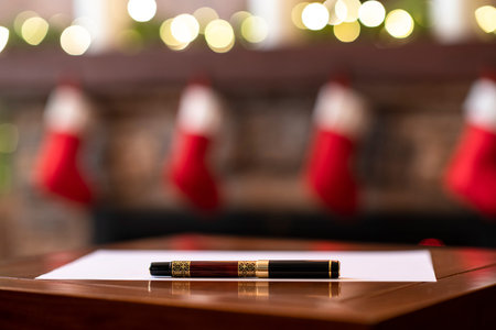 Fountain pen, sheet of on the table on background of christmas fireplace with decoration of light...