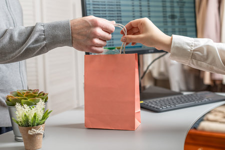 Man buying gift in a female clothing store.