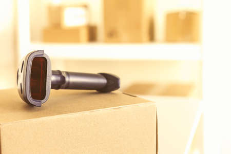 Woman employee of post office scanning parcel using barcode scanner to confirm sending customer. Home delivery service.の写真素材