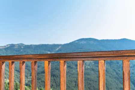 Wooden balcony railing in the mountainsの写真素材
