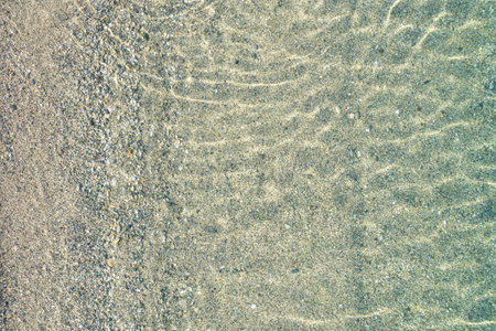 Blue, turquoise transparent water surface of ocean, sea, lagoon. Horizontal background. Top view of...