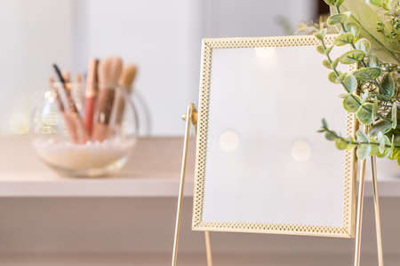 Table mirror on dressing table with make up accessories. Self-Care. White, pastel interiorの写真素材