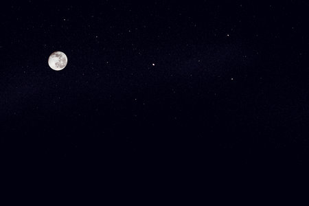 Huge full moon on the night blue star sky.