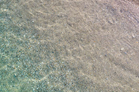 top, aerial view. Young beautiful woman in white bikini swimming in sea water on the sand beach. Drone, copter photo. summer holidays. view from above.の写真素材
