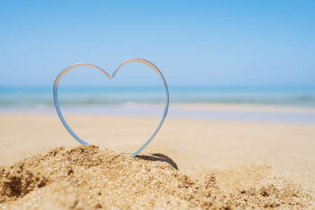 Sea view through shape of heart in the sand of tropical beach. valentines day. Holiday, holiday concept. Creative, background, copy space, travel, summer.の写真素材