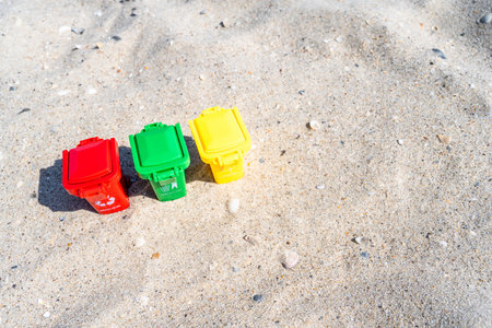 Various colored trash cans with paper, plastic, glass and organic waste suitable for recycling on...