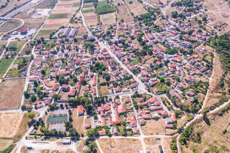 Aerial view of traditional village with rural houses, buildings, highway bridge, countryside roads in Greece. Drone, copter viewの写真素材