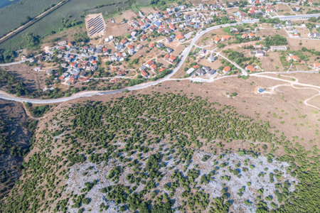 Woman standing by broken down car with open hood at countryside road. Aerial, top, drone viewの写真素材