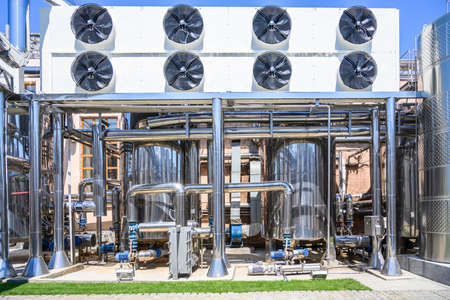 Wine steel tanks, equipment of contemporary winemaker factory. Barrels for wine storage. Equipment for the fermentation, distillation of alcohol. Preparation workshop for pure alcohols.の写真素材