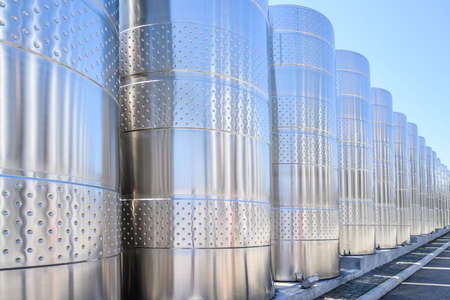 Wine steel tanks, equipment of contemporary winemaker factory. Barrels for wine storage. Equipment for the fermentation, distillation of alcohol. Preparation workshop for pure alcohols.の写真素材