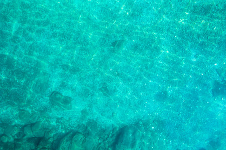 Blue, turquoise transparent water surface of ocean, sea, lagoon. horizontal background. Top view of...