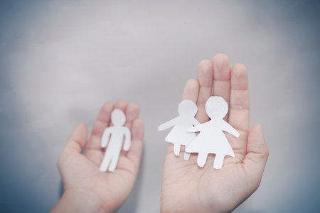 Paper children kids in woman mother hands on the sea sand beach. family concept.の写真素材