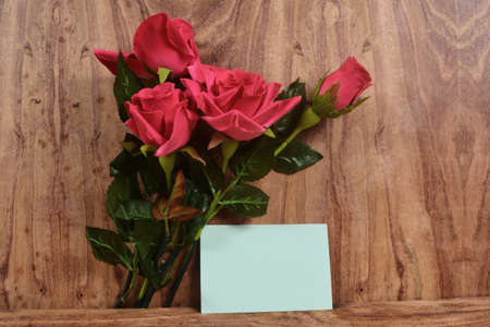 Valentine wooden background with hearts and flowersの写真素材