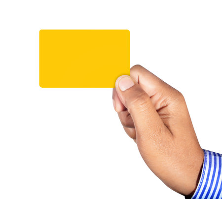 Hand holding yellow card isolated on white background professionally