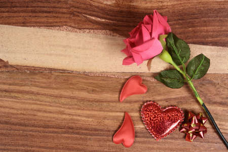Valentine wooden background with hearts and flowersの写真素材