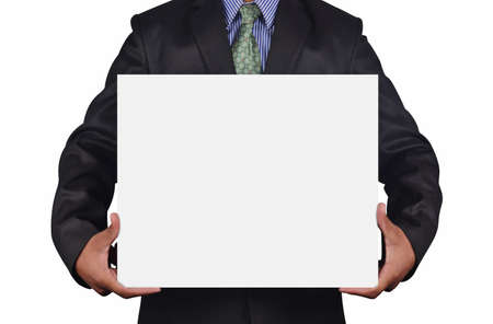 Businessman holding card in black suit isolated on white backgroundの写真素材