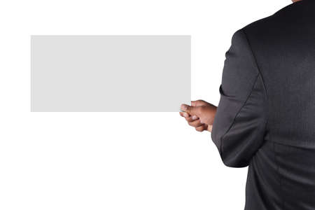 Businessman holding card in black suit isolated on white backgroundの写真素材