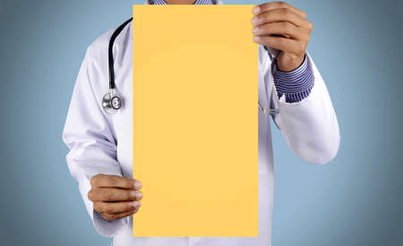 Doctor holding card with stethoscope isolated on color backgroundの写真素材