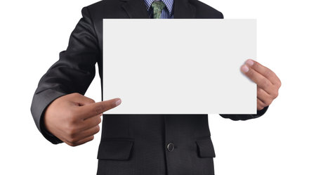Businessman holding card in black suit isolated on white background