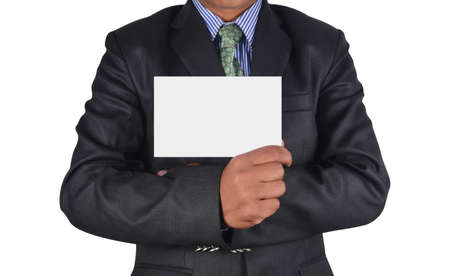 Businessman holding card in black suit isolated on white backgroundの写真素材
