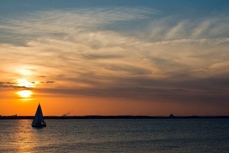 A sailboat on the Chesapeake bay in Maryland at sunsetの写真素材