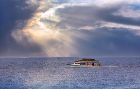Crab fishermen on a boat on the Chesapeake Bay in Maryland checking crab pots near sunsetの写真素材