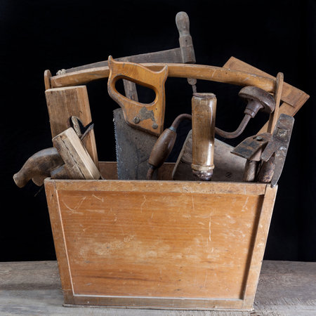 vintage carpenter toolbox with saw, hammer, planer, beater and twist drill