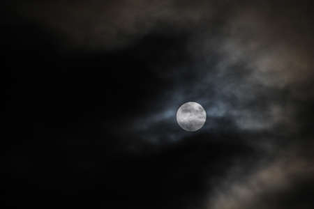 Full moon with dark clouds passing by.の写真素材