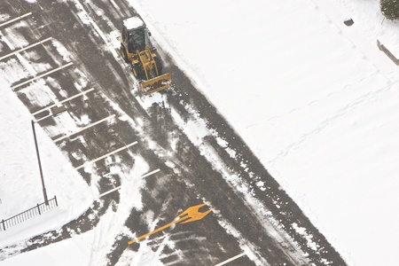 Wheel loader machine removing snow in winter on the roadの写真素材