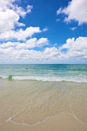 beach and tropical sea under the bright blue sky at summer dayの写真素材