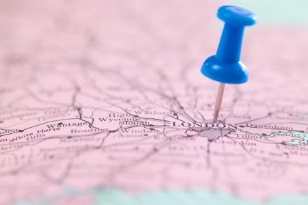 close up shot of push blue pin pointing on the map at London for travel backgroundの写真素材