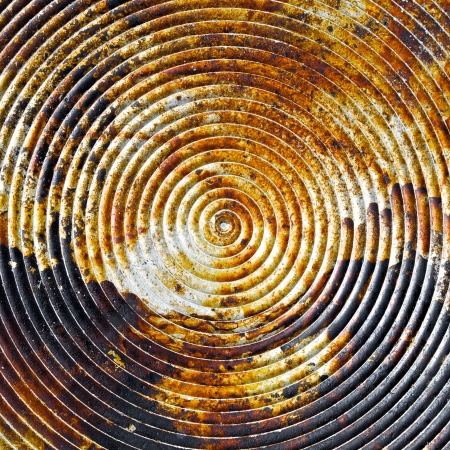 close up shot of old spiral on metal plate texture backgroundの写真素材